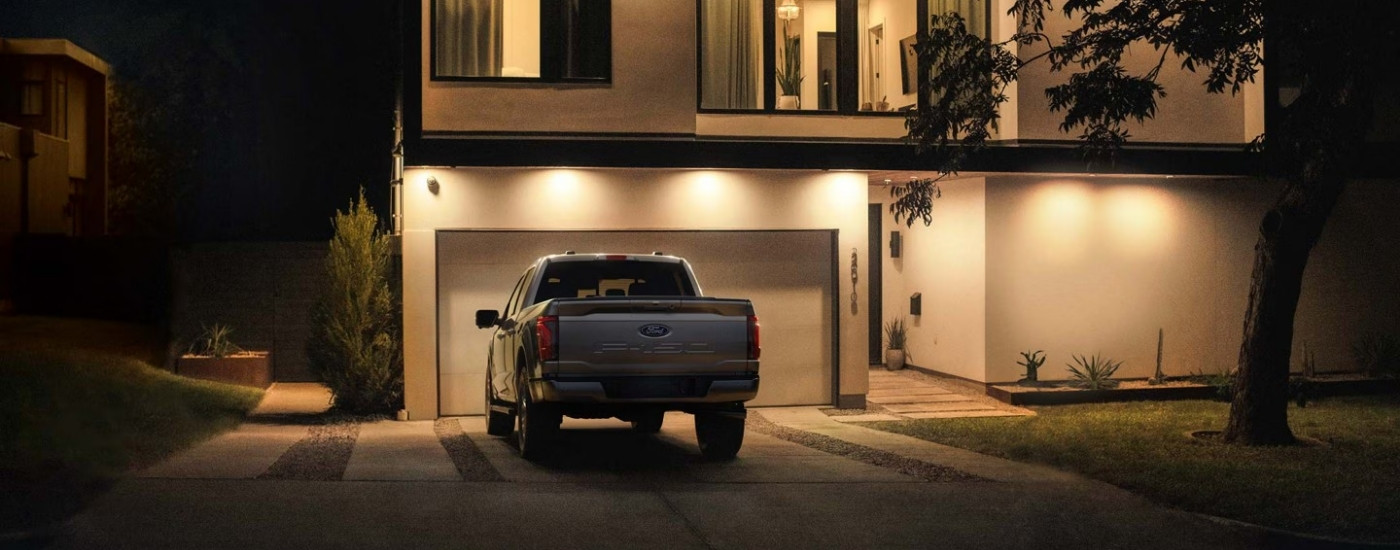 Rear of a grey 2026 Ford F-150 XL parked on a driveway.